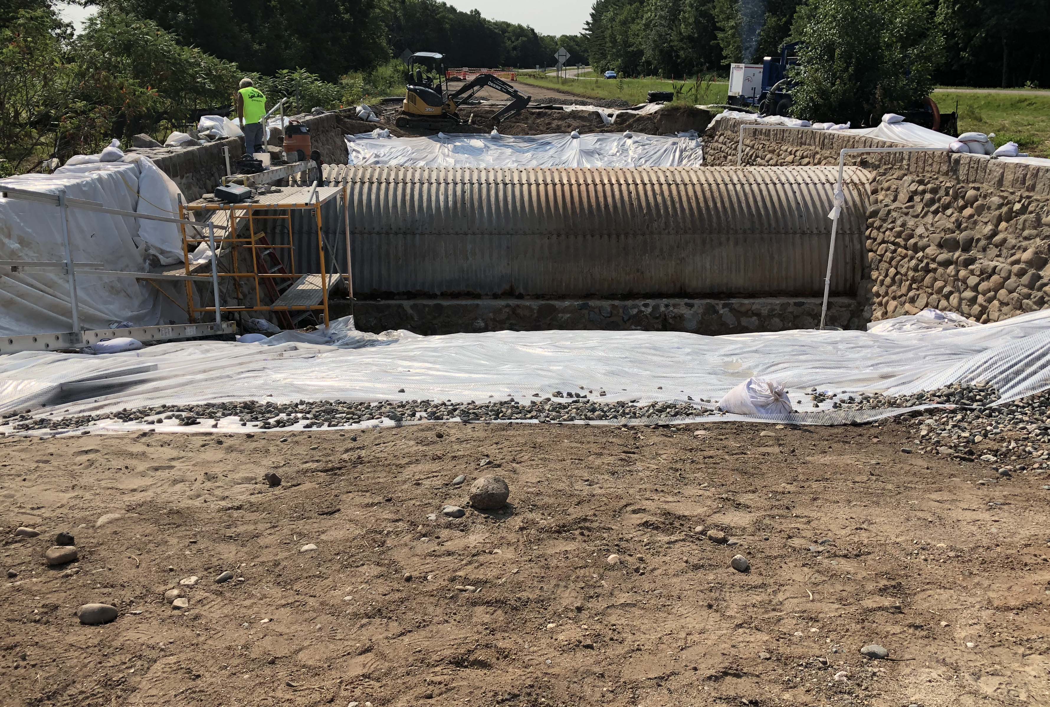 The corrugated steel arch and interior of the stone walls are exposed after excavating all of the fill material. The inside face of the stone will be repaired and the steel will have reinforcement added to correct corrosion during its 80 year life. September 2018 .